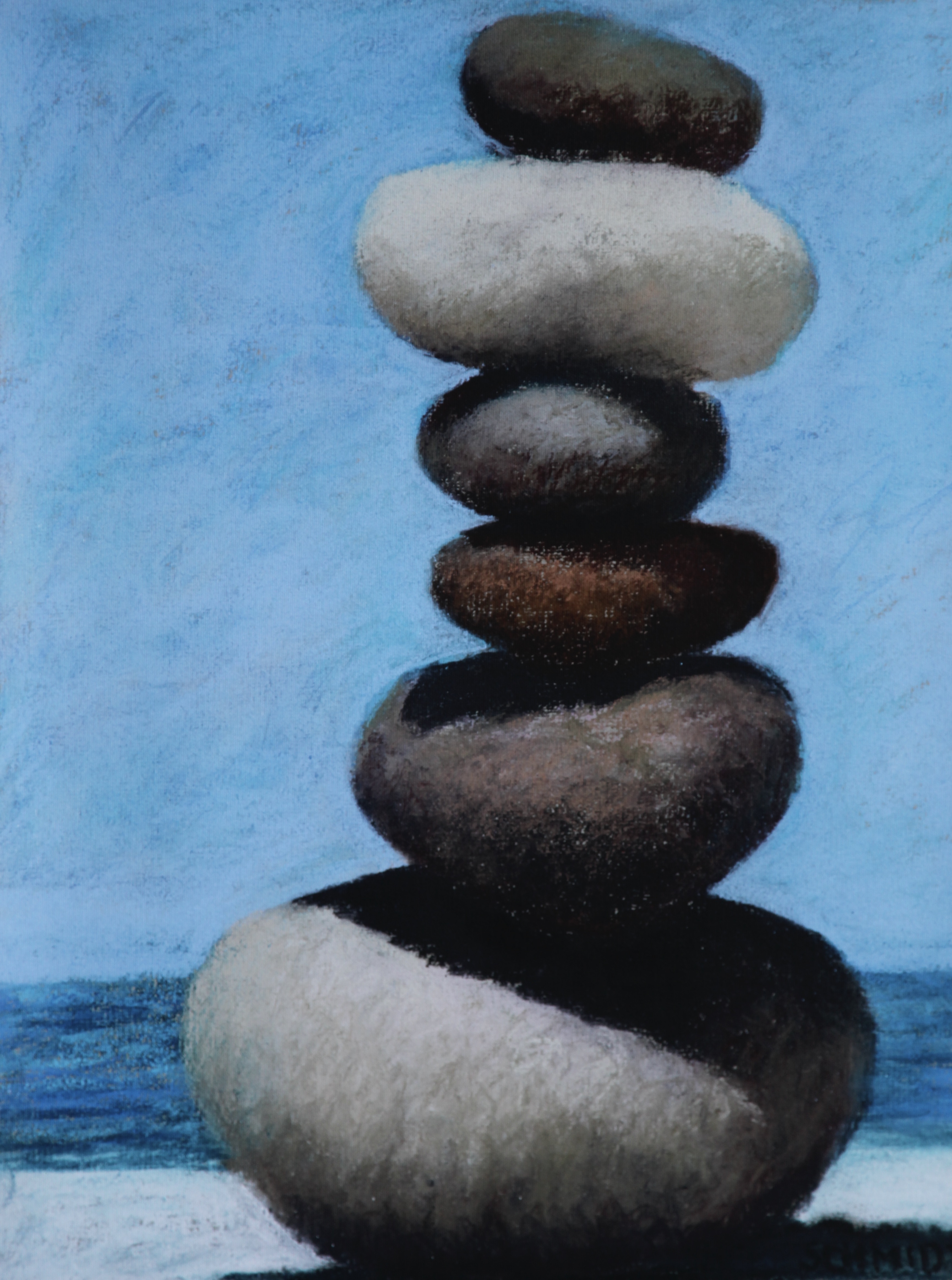 stack of rocks with sky and ocean behind